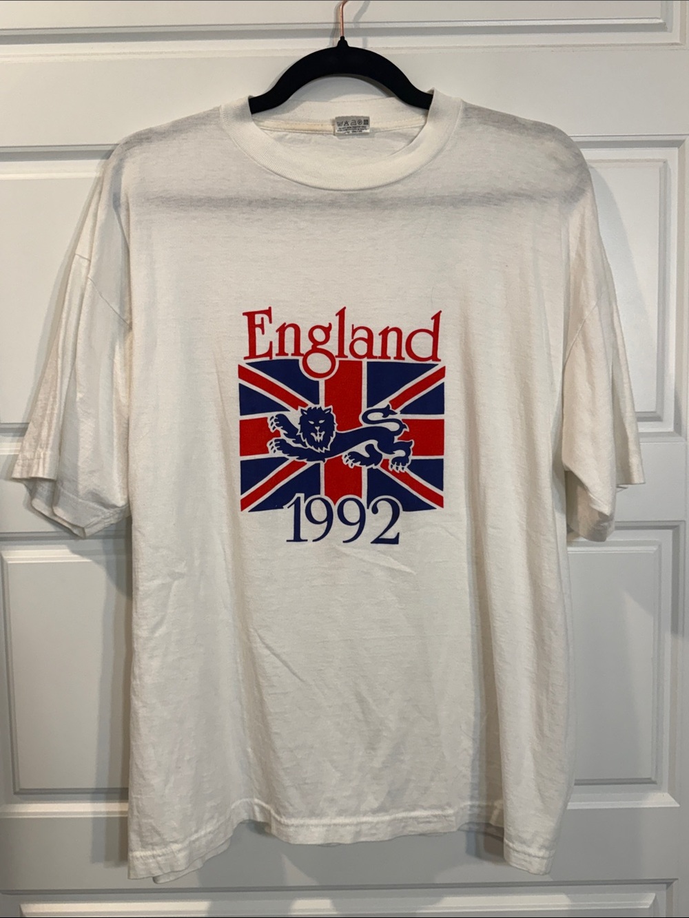 vintage white t-shirt features graphic of the Union Jack flag with a lion crest